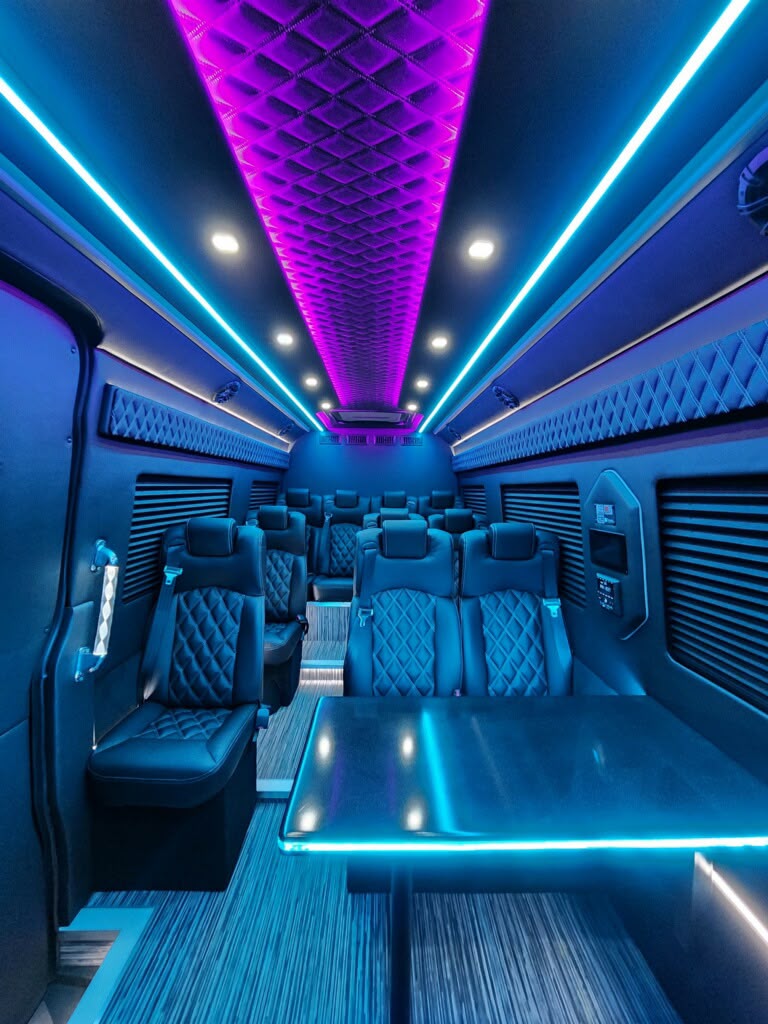 Sprinter cabin with quilted black seats and ambient lighting